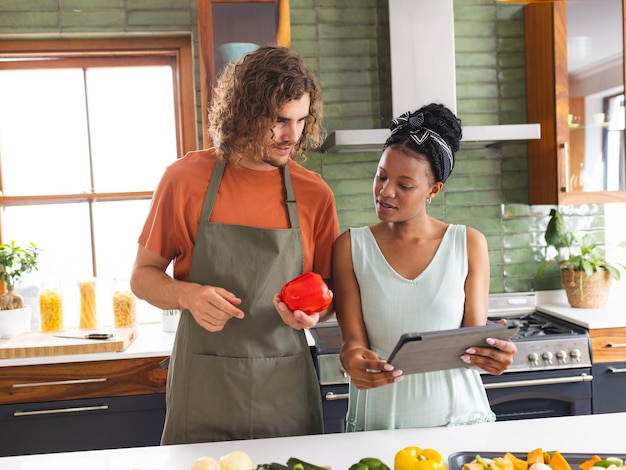 A diverse couple is cooking together in modern kitchen