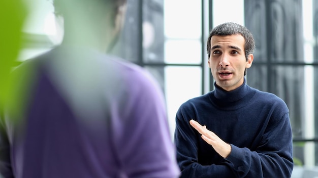 Diverse friendly male colleagues talking while walking