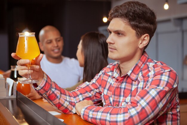 Diverse groep vrienden die bier drinken samen in de kroeg