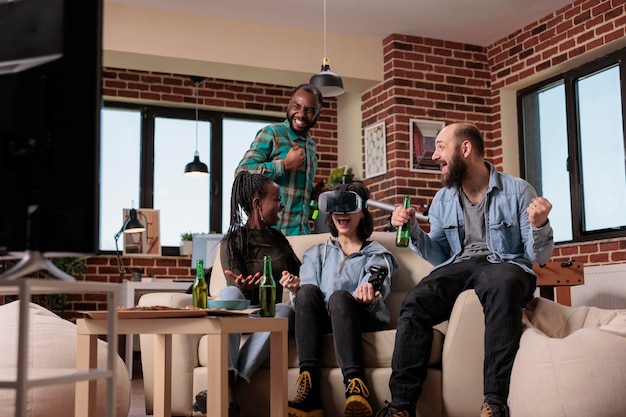 Diverse group of friends celebrating video games victory, winning game with augmented reality goggles on tv console. People using vr glasses to win competition at house party, leisure activity.