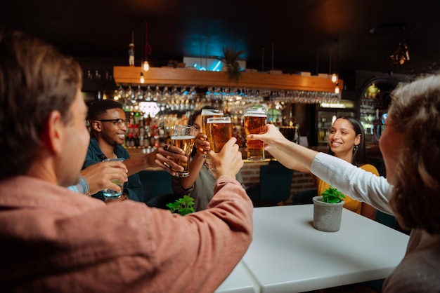 Diverse group of friends making a toast while at dinner