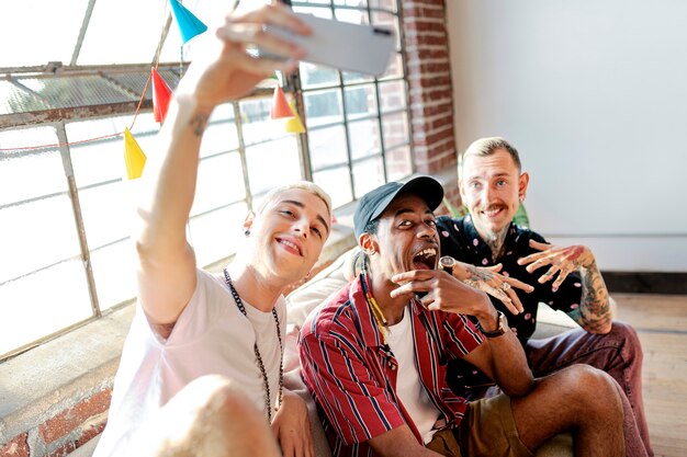 Diverse group of friends taking a selfie at a party