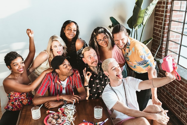 Diverse group of friends taking a selfie at a party