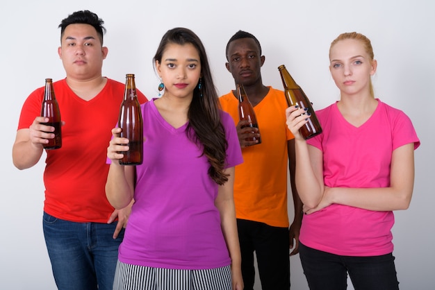 diverse group of multi ethnic friends holding bottles