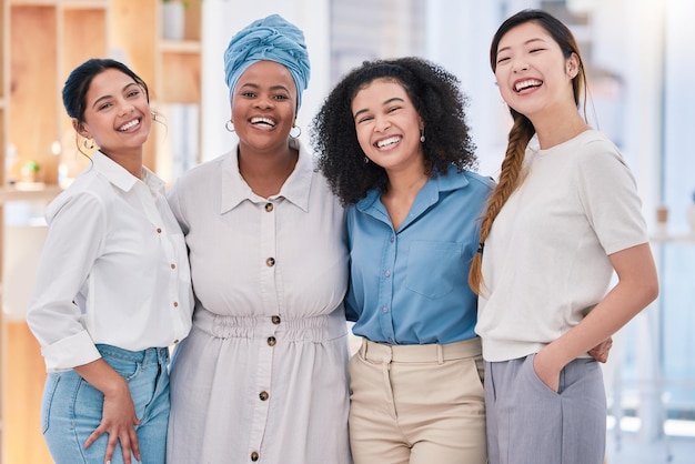 Diverse happy and smiling portrait of a creative team of designers standing in a modern office Young successful group of friendly casual coworkers employees or colleagues posing at the workplace