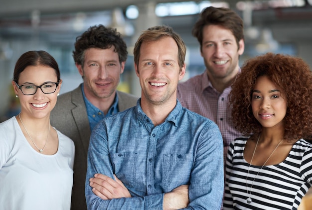 Diverse minds for strong business A diverse group of creative professionals looking positively at the camera