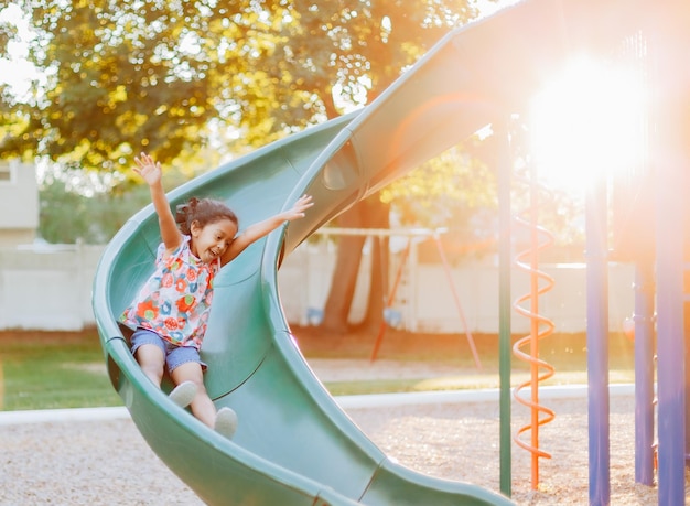 Diverse mixed race pre school age girl at park during a nice summer sunset