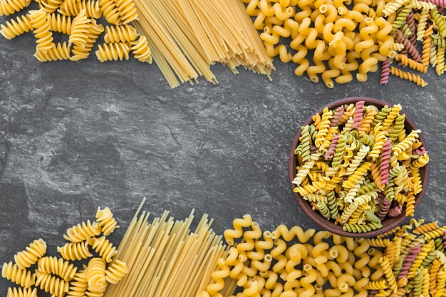 Diverse pasta op donkere stenen achtergrond