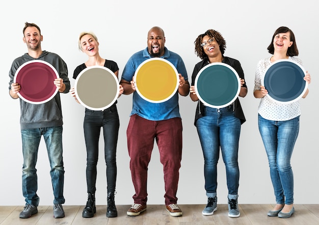 Diverse people holding blank round board