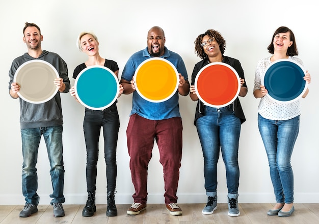 Diverse people holding blank round board