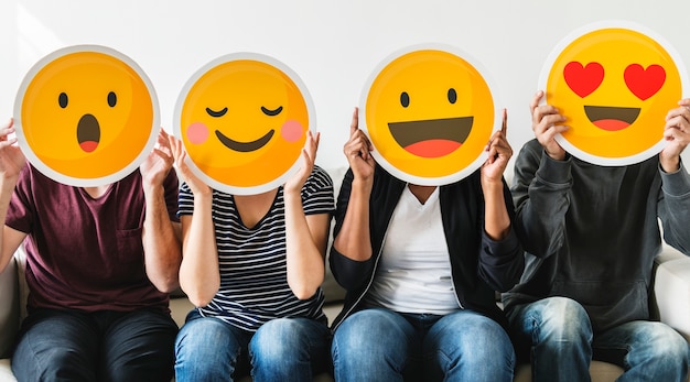 Photo diverse people holding emoticon