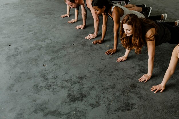 Diverse people practicing a Phalakasana pose