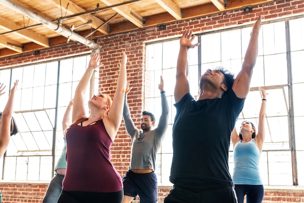 Diverse people practicing a Urdhva Hastasana pose