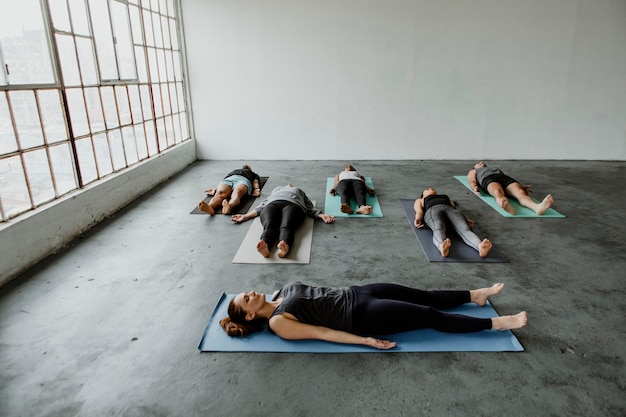 Diverse people in a Savasana pose