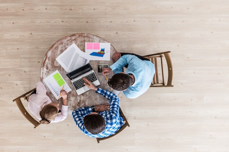 Diverse people working with financial reports and laptop