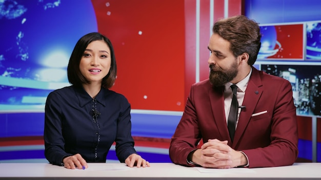 Diverse presenters hosting morning show to cover all news stories on global television network, international program. Man and woman journalists presenting media segment live on tv panel.