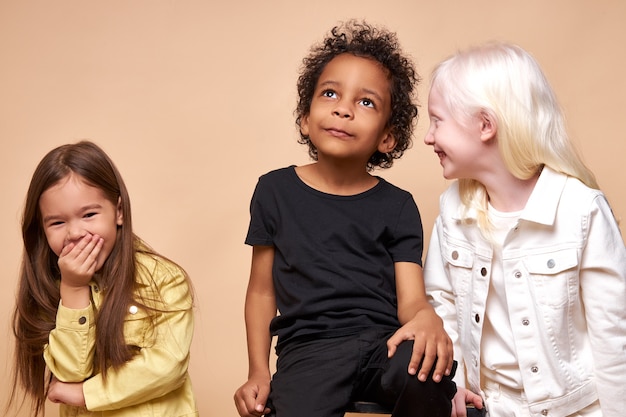 Diverse smiling positive children posing happy together