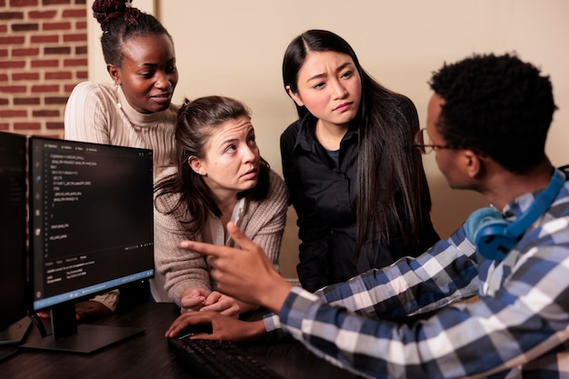 Photo diverse software developers programming application, typing html code on computer. cyber security company enginners encrypting cloud processing data system using blockchain technology.