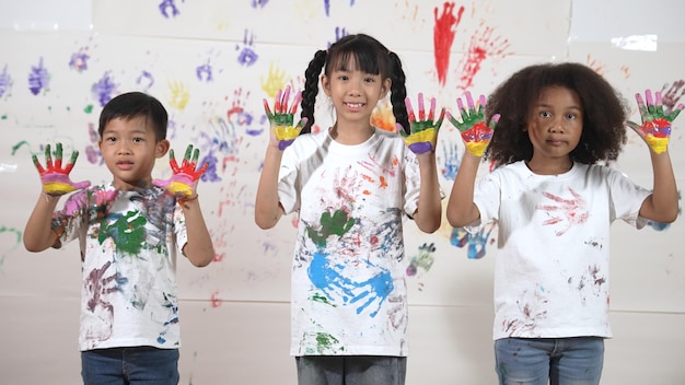 Diverse students put hands up together show colorful stained hands Erudition