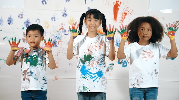 Diverse students put hands up together show colorful stained hands erudition