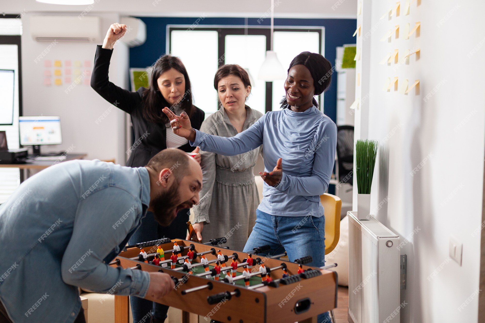 Group of diverse friends playing game on mobile phone Stock Photo