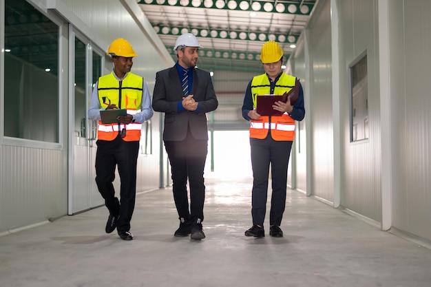 Diverse Team of Specialists Taking a Walk Through factory Site Real Estate Building Project with Senior Civil Engineer Architect General Worker Discussing Planning and Development Details