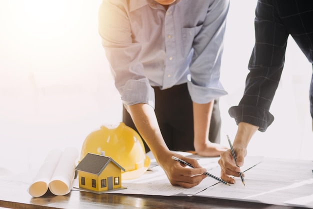 Diverse Team of Specialists Use Tablet Computer on Construction Site Real Estate Building Project with Civil Engineer Architect Business Investor and General Worker Discussing Plan Details