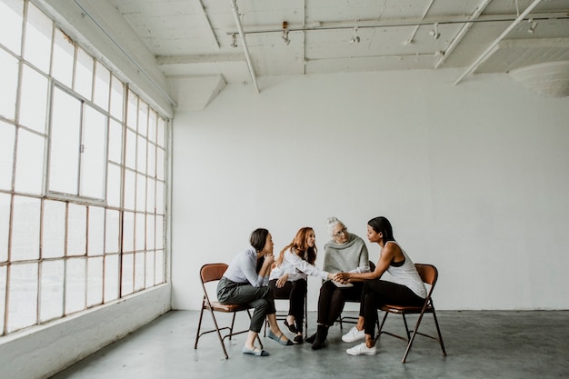 Diverse women in a  supporting group session