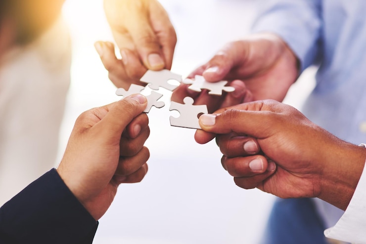 Photo diversity business and hands of people with puzzle for unity or collaboration with joint effort for project group teamwork and pieces together for planning or partnership union and engagement