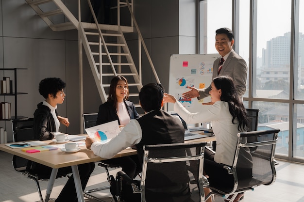 Photo diversity businesspeople brainstorming and discussing with happiness in modern meeting room teamwork