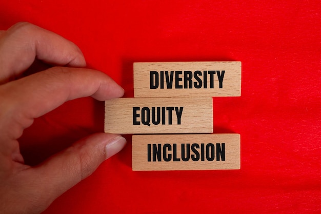 Photo diversity equity and inclusion message written on wooden blocks with color background