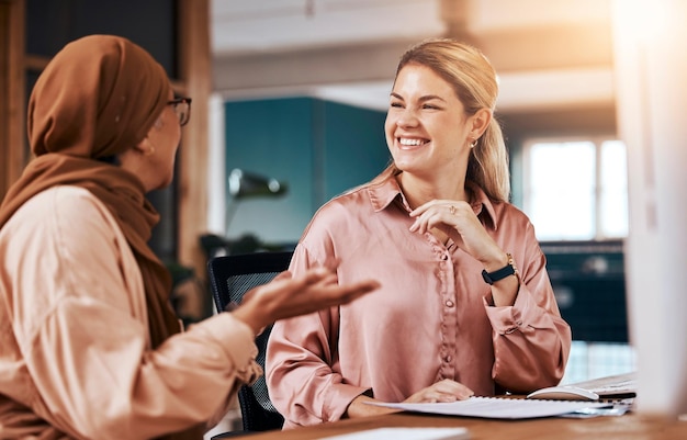 Diversity Islamic and business women talking or in conversation together planning in a company office Happy employees and friends in collaboration or Muslim colleague in discussion on a break