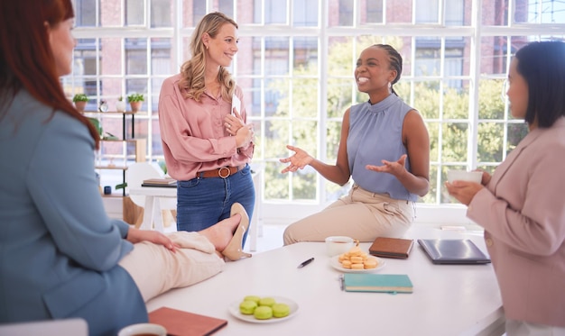 Photo diversity lunch and business women relax in an office building talking gossip or share news after meeting team building black woman and friends speaking enjoying a conversation together on break