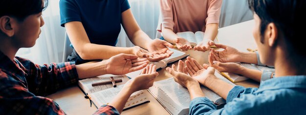 写真 多様性の人々 手を合わせて聖書の本で 誠実に祈っています