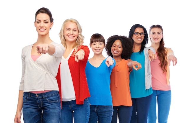 diversity, race, ethnicity and people concept - international group of happy smiling different women over white pointing finger at you