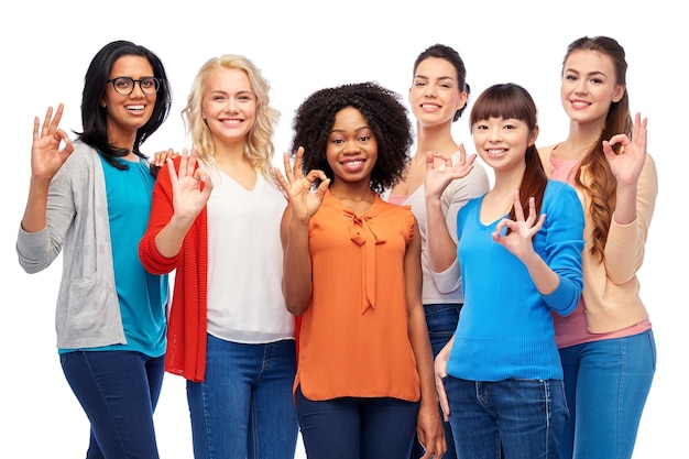diversity, race, ethnicity and people concept - international group of happy smiling different women over white showing ok hand sign