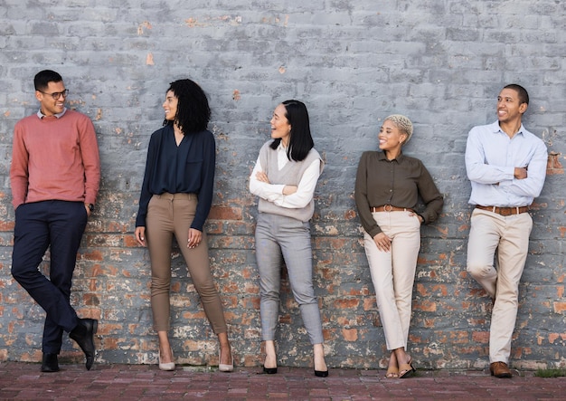 Photo diversity smile and team standing at wall at creative startup company waiting for recruitment human resources job opportunity and group of happy hr employees in row business people stand together