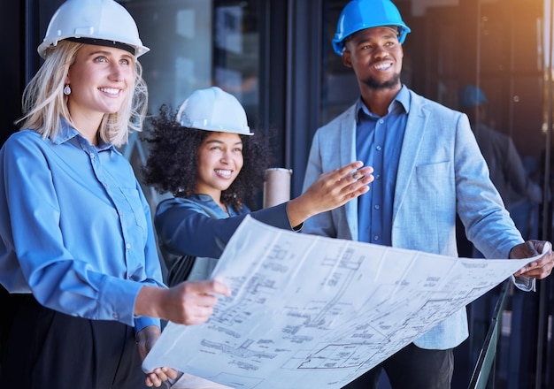 Diversity team and creative architect people working on a site
plan with blueprint for construction or building business
contractors in teamwork planning and strategy with paper design
layout