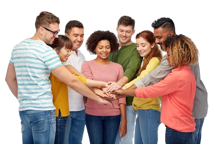 Photo diversity, teamwork, race, ethnicity and people concept - international group of happy smiling men and women holding hands together over white