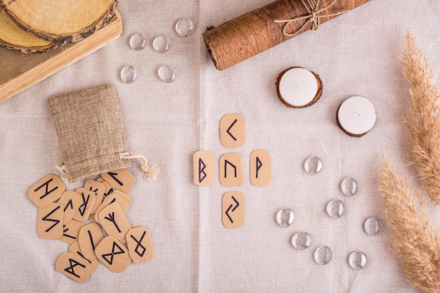 Divination by a cross on homemade Scandinavian runes on the table top view