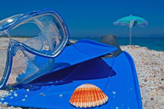 Diving fins and mask on a sunny beach