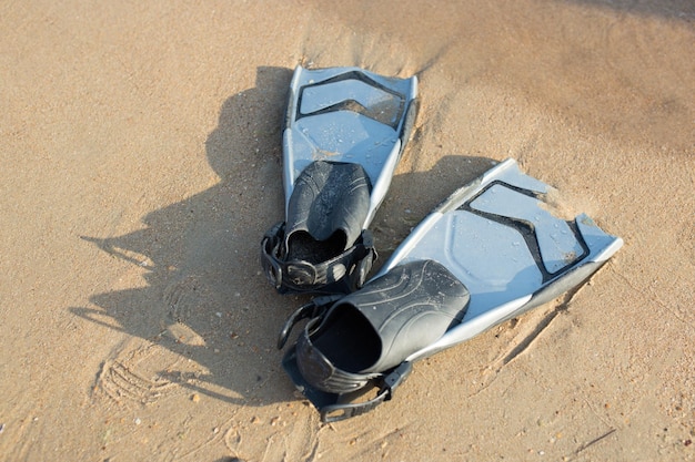 Diving fins on the sand Summer activities sport concept