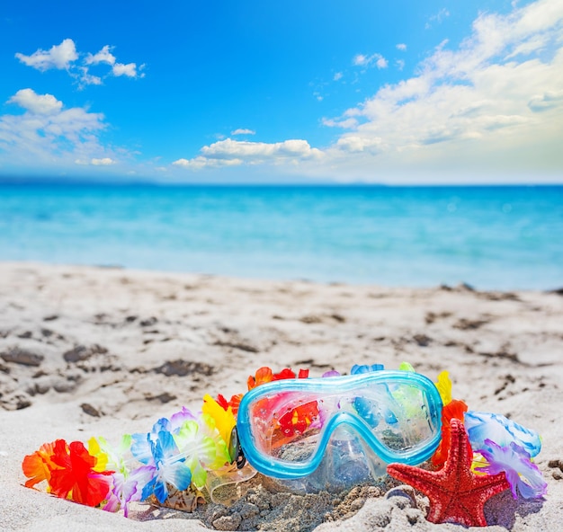 Diving mask and red sea star on a tropical beach