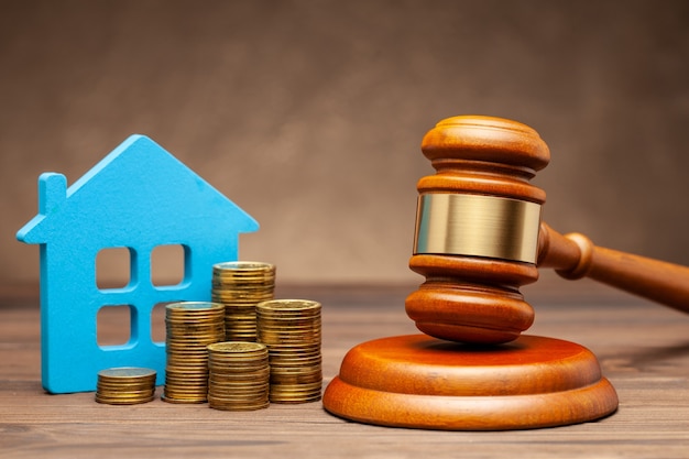 Divorce by law. Division of property after a divorce. House with money and a judge gavel.