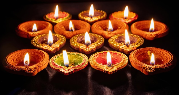 Diwali Deepavali Hindu festival of lights Diya lamp lit on black close up