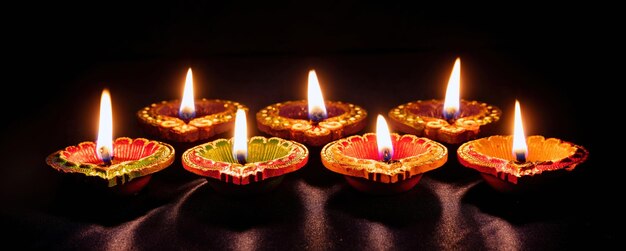 Diwali Deepavali Hindu festival of lights Diya lamp lit on black close up