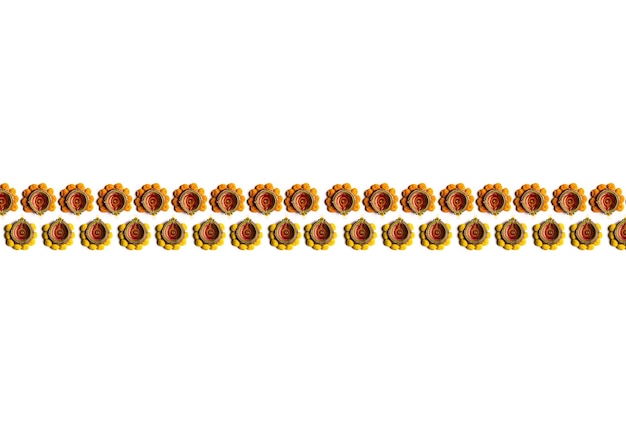 Diwali diya or oil lamp with marigold arranged as a border or strip over white scene