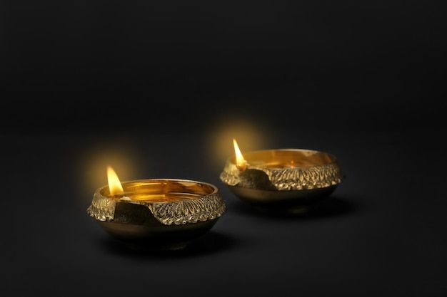 Diwali diyas or clay lamps on dark background