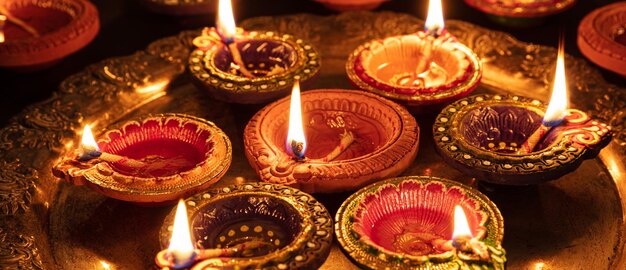 Diwali Hindu festival of lights celebration Diya oil lamps against dark background