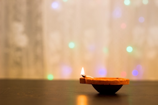 Diwali Hindu festival of lights Clay diya candle illuminated in Dipavali wth copy space
